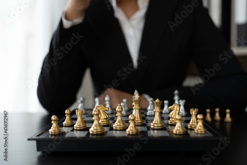 Investor playing chess board game conceptual image of businessman holding chess piece in business competition and risk management Plan a business strategy to beat your competitors. leadership concept