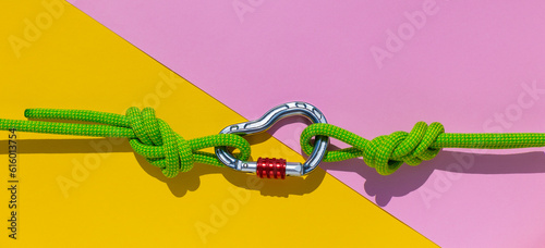 Obraz na plátně carabiner with a rope lies on a colored background