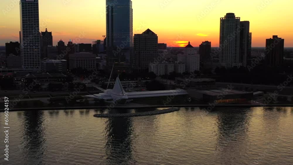 Aerial video view of sunset reflection over lake and city skyline Aerial video view of sunset reflection over lake and city skyline