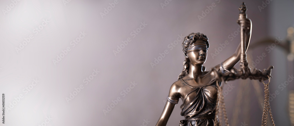 Law symbols composition. Gavel, scale and Themis sculpture on the gray background.