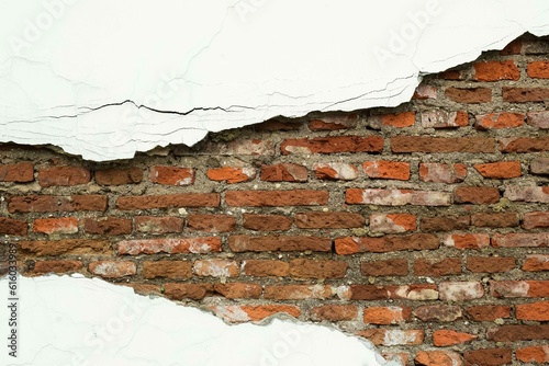 Old red brick wall with peeling plaster