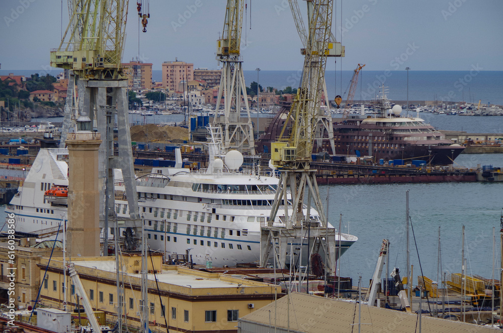 Italian shipbuilder dry dock ship building facilities in Palermo, Sicily Italy with massive construction cranes and docks and luxury cruiseship cruise ship liner maintenance modernisation overhaul ren Italian shipbuilder dry dock ship building facilities in Palermo, Sicily Italy with massive construction cranes and docks and luxury cruiseship cruise ship liner maintenance modernisation overhaul ren
