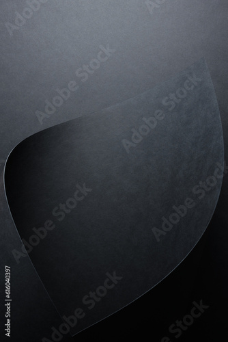 dark wallpaper rolled up black sheet of paper against a black background
