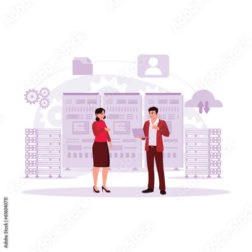 A Male IT expert working on a laptop, discussing system problems with a female server technician expert in the office data centre room. Trend Modern vector flat illustration.