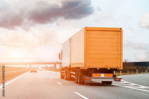 Yellow truck on the highway. Semi truck lorry is shipping internationally. Courier, parcel and express mail service. Copy space template and mock-up for shipping company.