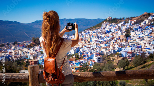 Woman tourist taking picture of blue city- Chefchaouen in Morocco © M.studio