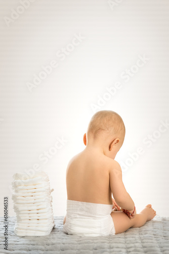 Baby from back sitting on white