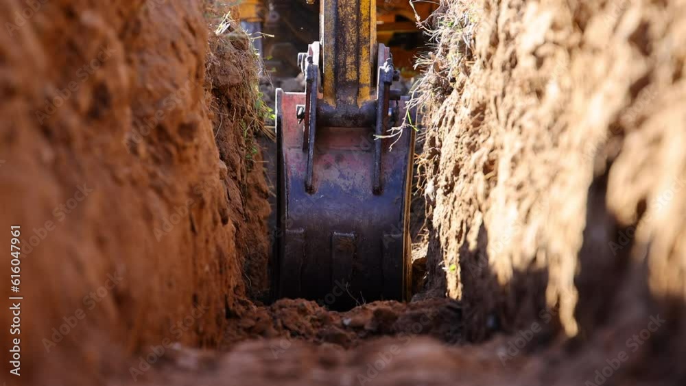 Excavator Digging a Trench for Building Foundation