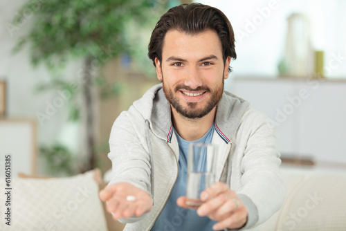 man holding out medicine tablet