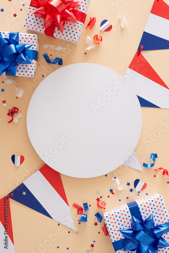 Gifting on Bastille Day concept. Top view of gift boxes in national color, french flag garlands, hearts, confetti on pastel beige background with blank circle for promo or text