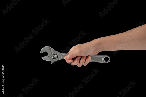 A wrench in hand isolated on black background.