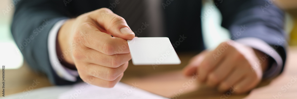 Manager handing out business card to client at work in office closeup. Exchanging contacts on meeting concept