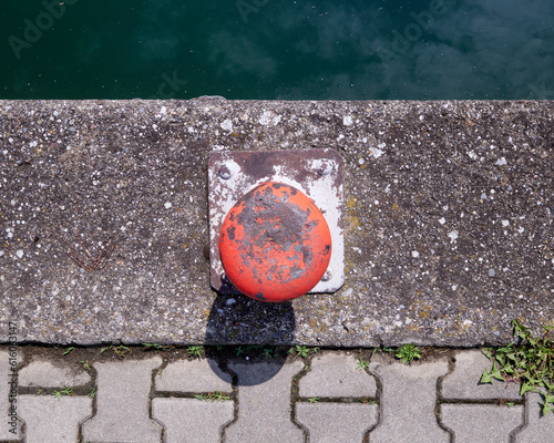 A moored red pleasure boat in a marina