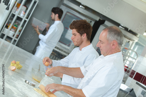 baker with students in kitchen making pastries