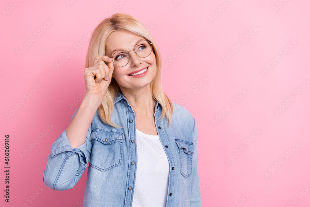 Photo of senior attractive lady demonstrating computer glasses advice low price shopping banner poster isolated pink color background Photo of senior attractive lady demonstrating computer glasses advice low price shopping banner poster isolated pink color background