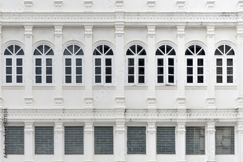 close-up shot of a white building with columns and windows. The photo highlights the urbanism, architecture, and geometric structure of the building