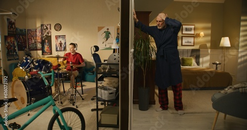 Fotografija Young boy plays on drum kit at home