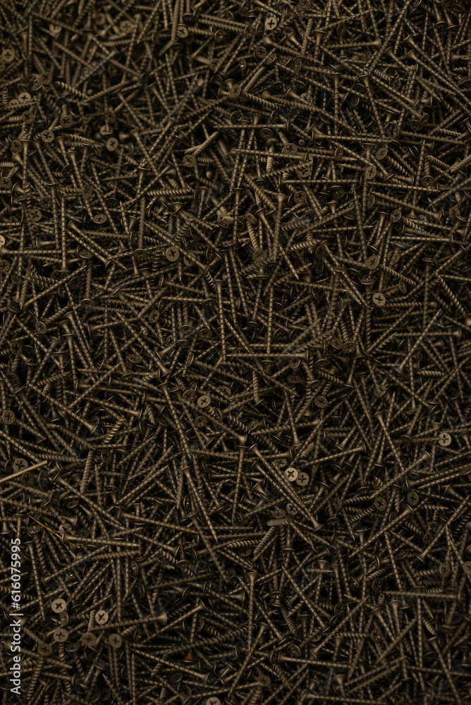 Lots of copper screws as a background. Selective focus. Lots of copper screws as a background. Selective focus.
