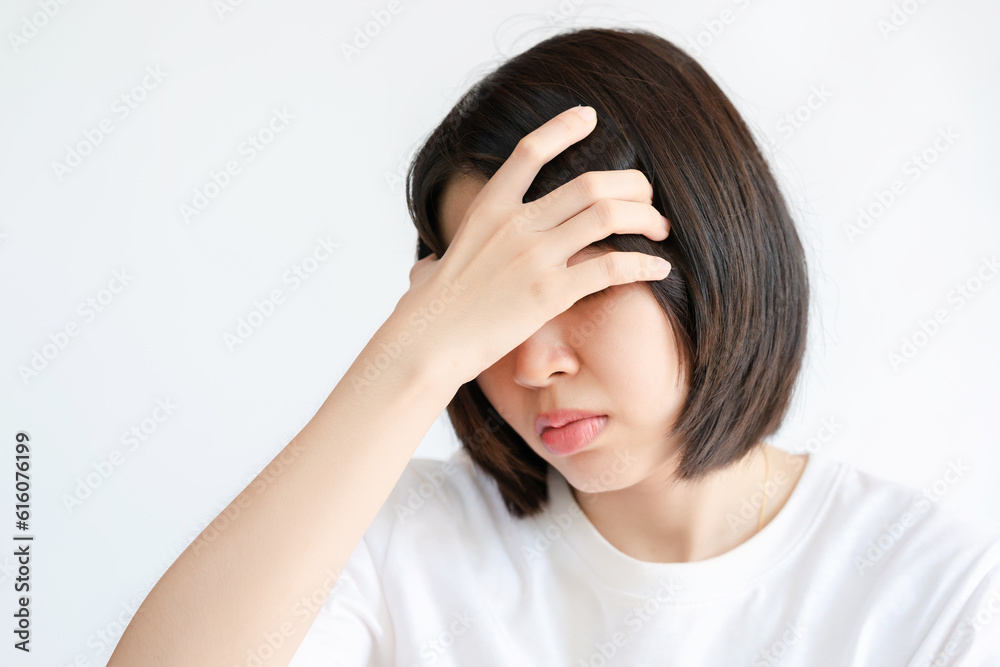Woman massaging head because of migraine headache. Concept of health problems. Woman massaging head because of migraine headache. Concept of health problems.