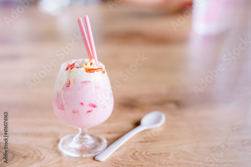 Ice cream in cups and spoons on the table.