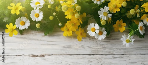 yellow spring flowers are laid out on a wooden background. Top view © jambulart