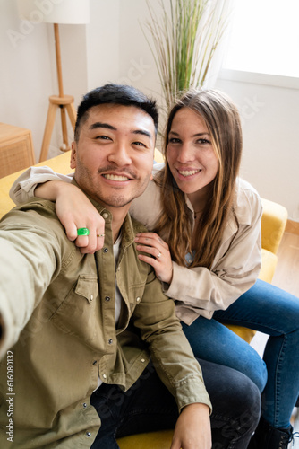 Young couple taking selfie in their new home.