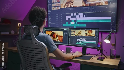 Young editor works at home office, edits sound tracks for video or movie about space mission. Film footage and software interface with tools on PC and big digital screen. Concept of post production. photo