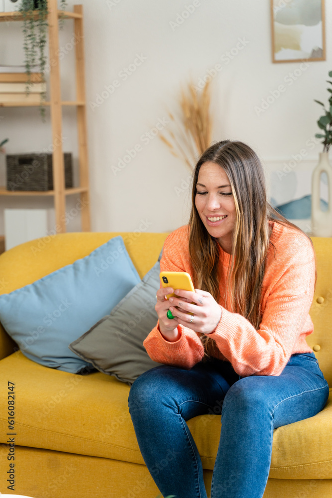 Young woman smiling while looking at social networks on smart phone. Young woman smiling while looking at social networks on smart phone.