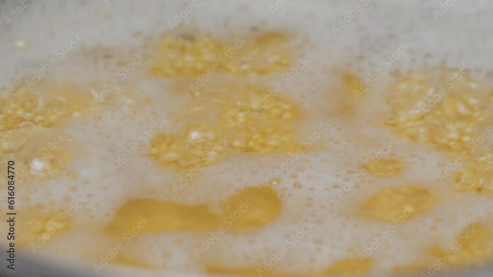 Cooking cereals in boiling water quinoa close-up, selective focus. Cooking cereals in boiling water quinoa close-up, selective focus.