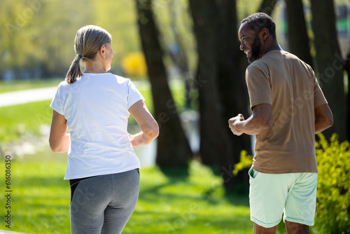 Mature couple jogging in the park in the morning