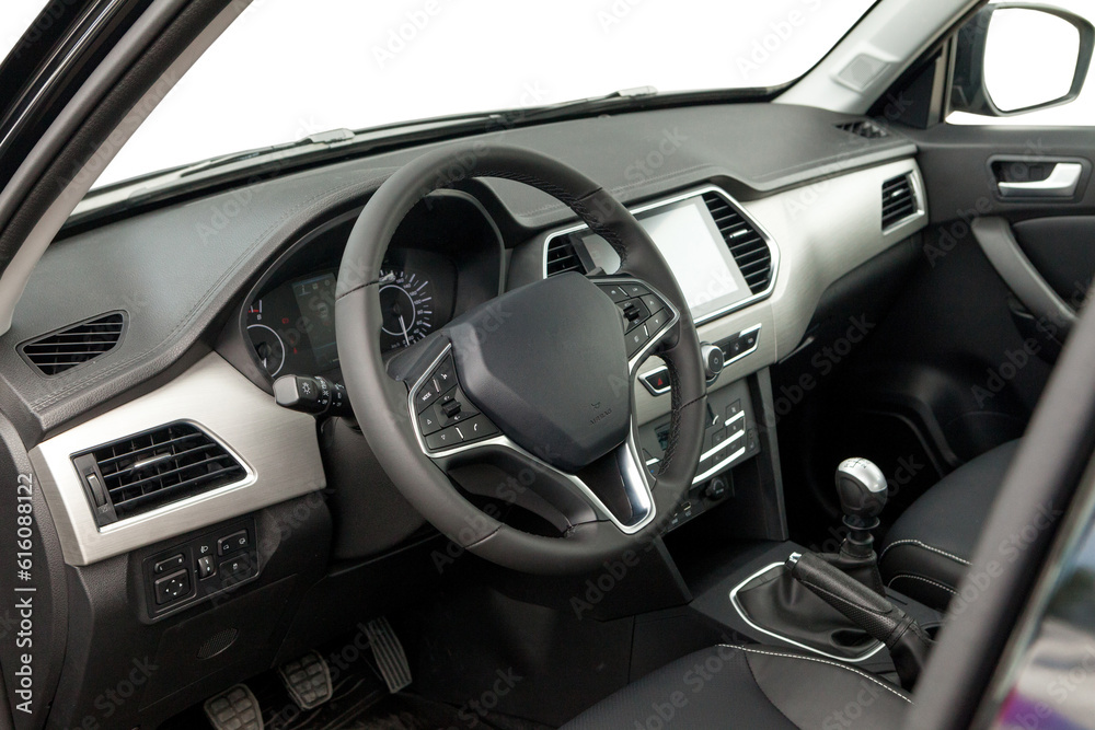 Interior of prestige modern car. Front seat with display, steering wheel and dashboard Interior of prestige modern car. Front seat with display, steering wheel and dashboard