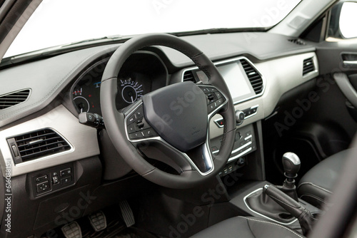 studio photo of car inside driver seat. Interior of prestige modern car. Front seat with display, steering wheel and dashboard © AvokadoStudio