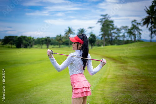 Professional woman golfer teeing to hole in player tournament competition at golf course for winner with green golf background. 