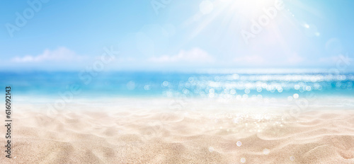 Fototapeta Naklejka Na Ścianę i Meble -  Sand With Blue Sea - Beach Summer Defocused Background With Glittering Of Sunlights