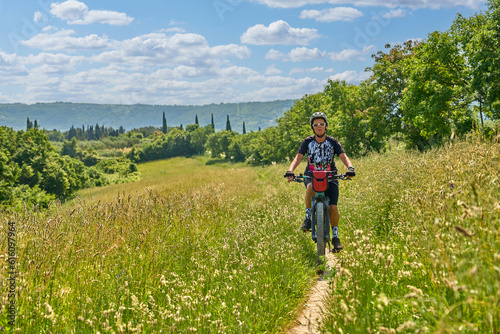 nice active senior woman on a bike tour with their electric mountain bikes in the Karst Mountains of Slovenia near Solkan