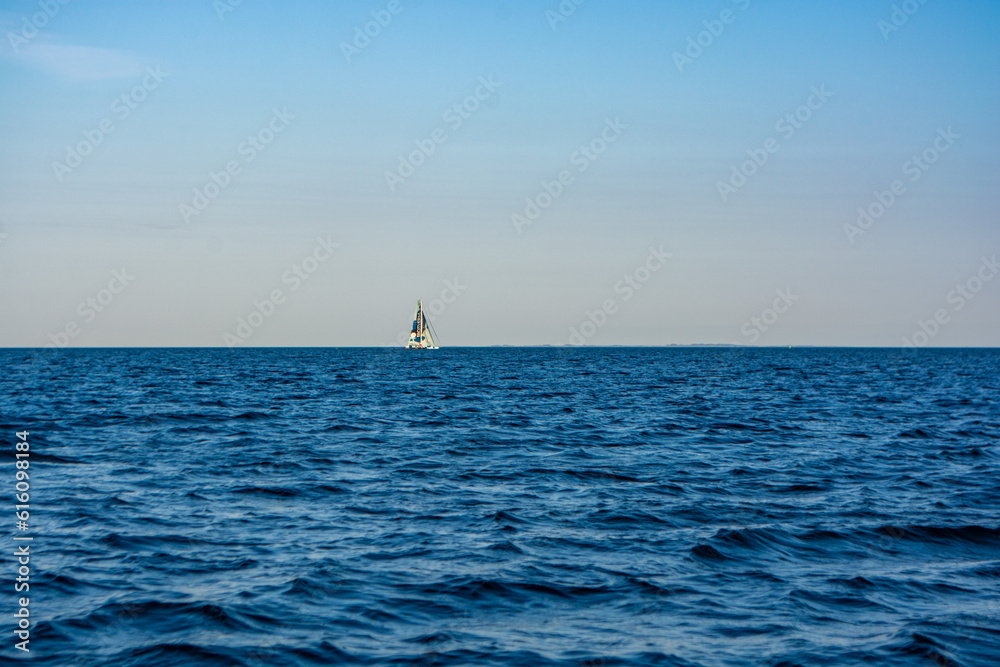 Sailboat in the sea in the evening sunlight at Aarhus, Denmark Sailboat in the sea in the evening sunlight at Aarhus, Denmark