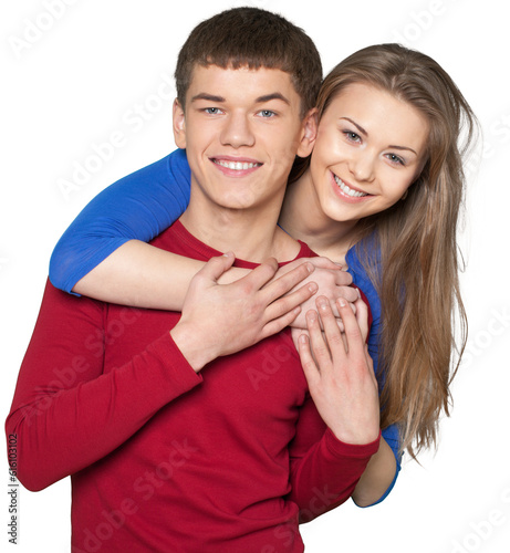 Young woman hanging over the shoulders of a young man