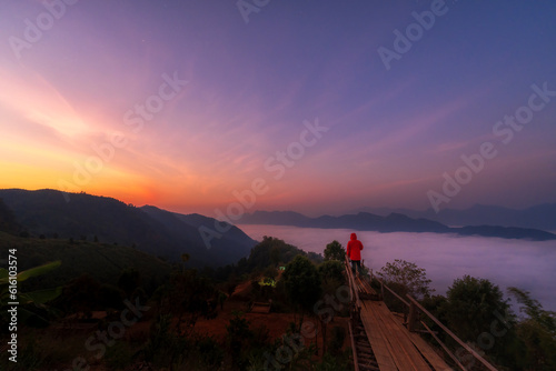 This man was a mist in the mountains with beautiful nature. Male on mountain view between the hiking route Gloselo, Mae hong son, Thailand. photo