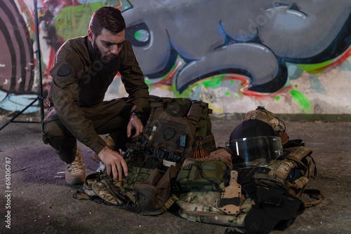 Army body armor, helmet and ammunition, Kalashnikov assault rifle with matrons and first aid tourniquet composition on brown wood. Army body armor. flat laying. military concept.