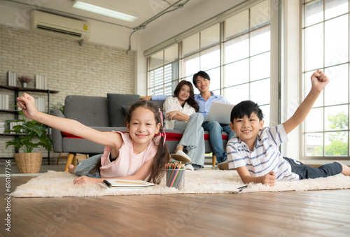 A boy and a daughter from an asian family. The children are having fun in the art of drawing. photo