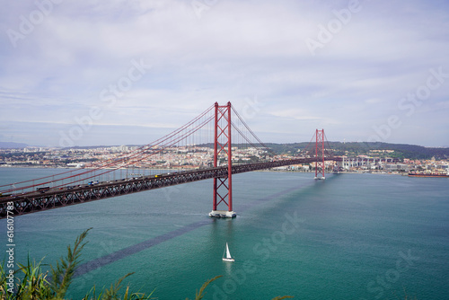 Lisbon, Portugal - March 2023: View of the April 25 Bridge and the city of Lisbon. 25 de Abril Bridge