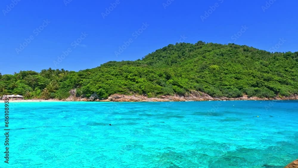 Kho Rasha island off the coast of phuket thailand by speed bias from Chalong Bay, beautiful turquoise Blue beach with white soft sand and lush green trees Kho Rasha island off the coast of phuket thailand by speed bias from Chalong Bay, beautiful turquoise Blue beach with white soft sand and lush green trees