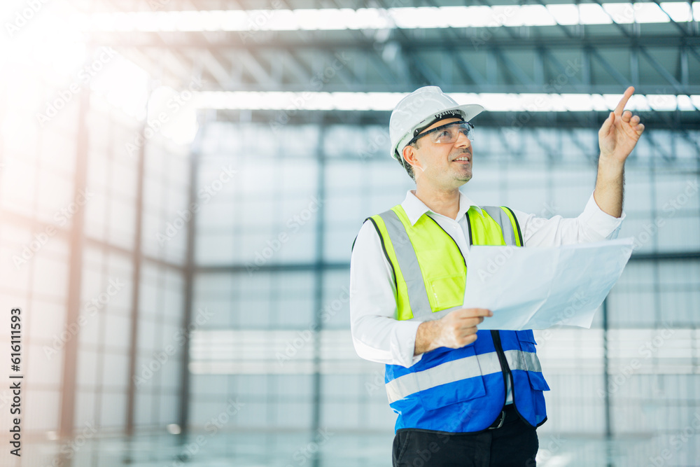 warehouse manager with tablet and radio communication his worker working in background in warehouse distribution center environment. Business warehouse inventory,contruction warehouse warehouse manager with tablet and radio communication his worker working in background in warehouse distribution center environment. Business warehouse inventory,contruction warehouse