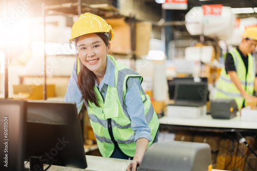 Warehouse workers using a digital tablet while recording inventory. Logistics employees working with warehouse management software in a large distribution centre.