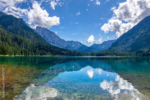 Mountain lake Relax by the side of a crystal-clear lake nestled at the foot of towering mountains, and soak in the beauty of the mountains and their reflections