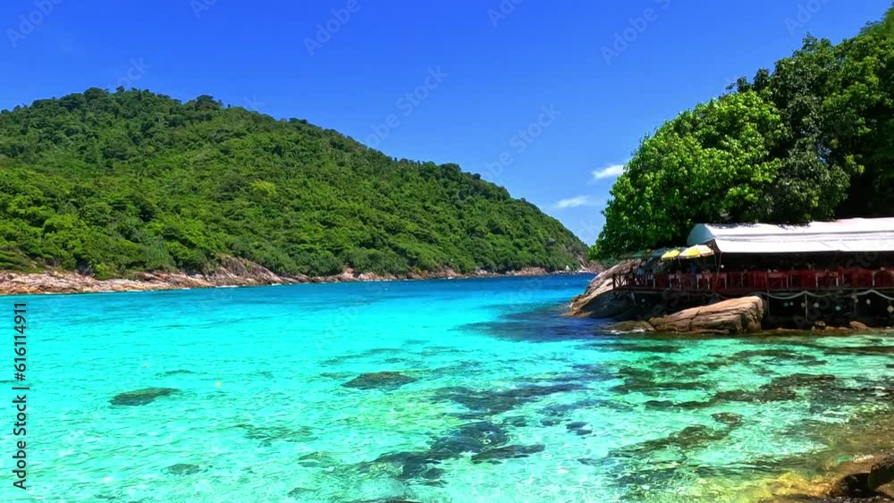 Kho Rasha island off the coast of phuket thailand by speed bias from Chalong Bay, beautiful turquoise Blue beach with white soft sand and lush green trees 