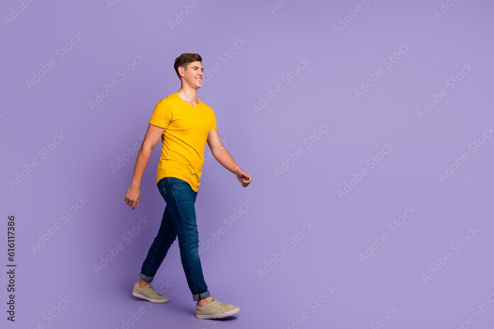 Full length body size photo smiling man in casual clothes walking forward isolated pastel purple color background Full length body size photo smiling man in casual clothes walking forward isolated pastel purple color background