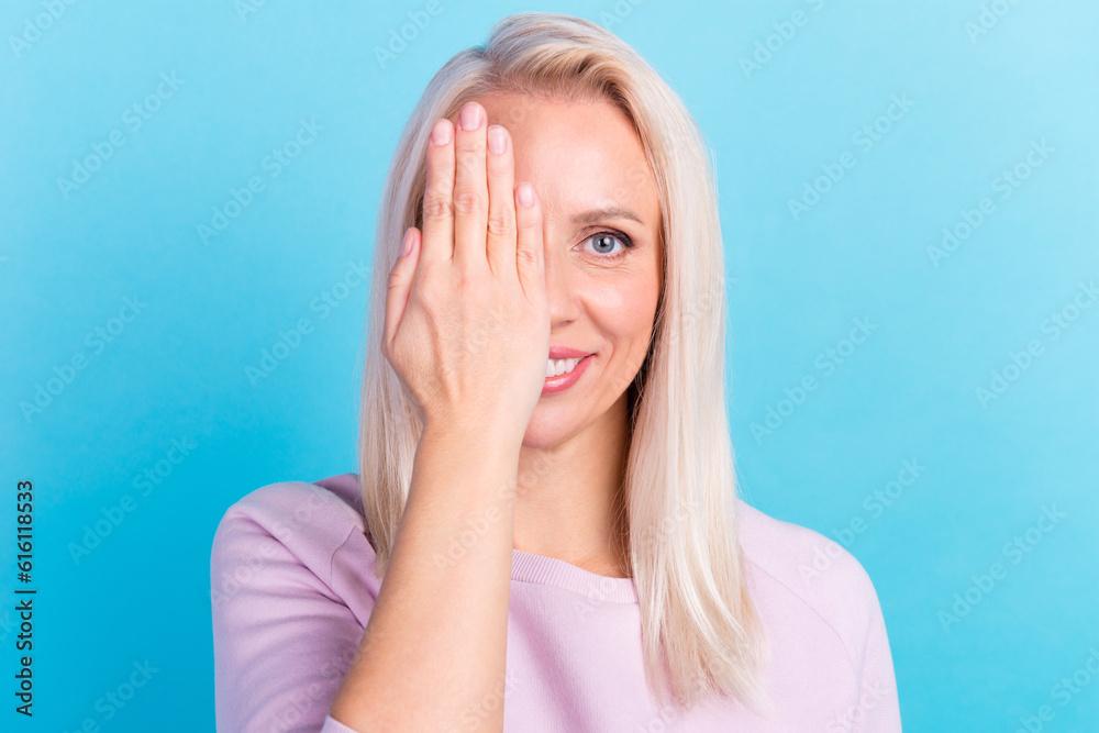 Portrait of young smiling good mood female cover close half face eyesight vision isolated blue color background Portrait of young smiling good mood female cover close half face eyesight vision isolated blue color background