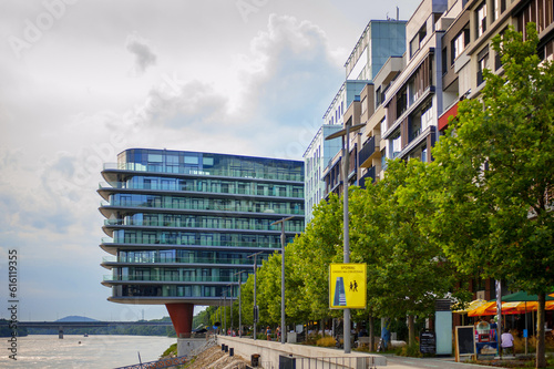 Photography modern office building with a glass facade and trails along the perimeter on the