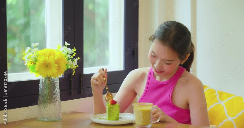 Beautiful Asian woman eating delicious cake in the coffee shop. cheat day for diet food lose weight concept.